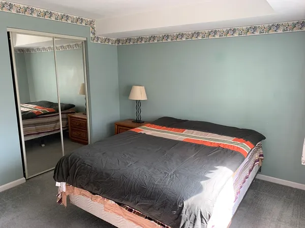 a bedroom with a bed and a lamp