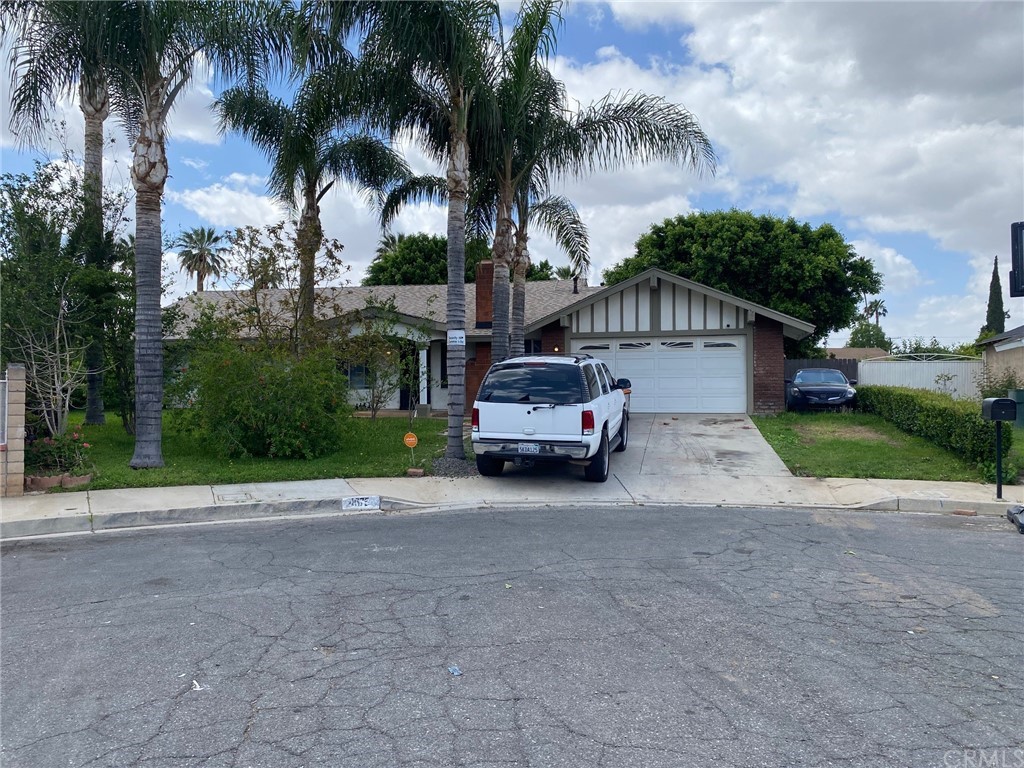 4675 Argentina Court Riverside, CA 92507 - Photo 1 of 1 a house with a yard and a car park in front of the house