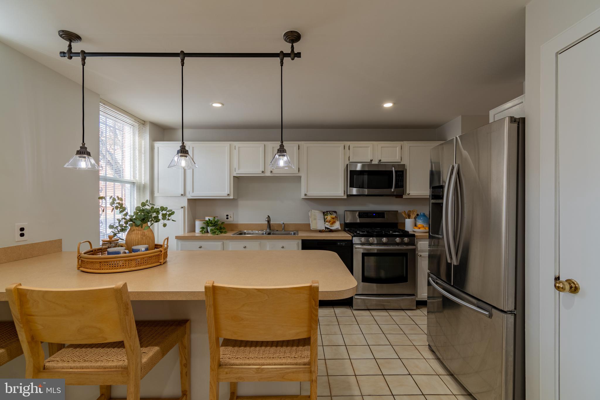 205 Scott Street Baltimore, MD 21230 - Photo 16 of 51 a kitchen with stainless steel appliances granite countertop a sink refrigerator and microwave