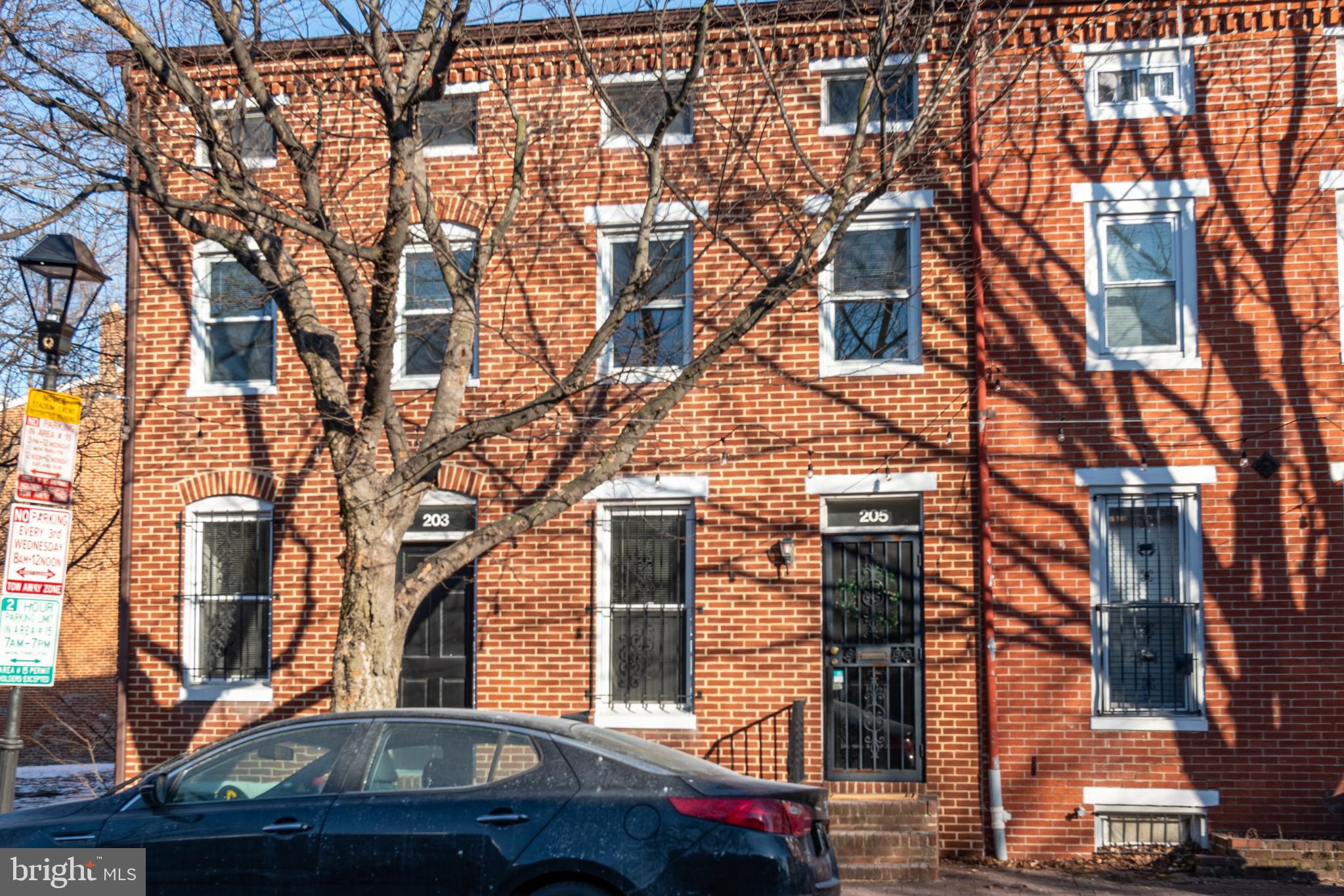 205 Scott Street Baltimore, MD 21230 - Photo 48 of 51 a front view of a building with large trees