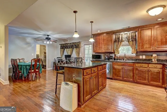 a kitchen with lots of counter top space and wooden floor