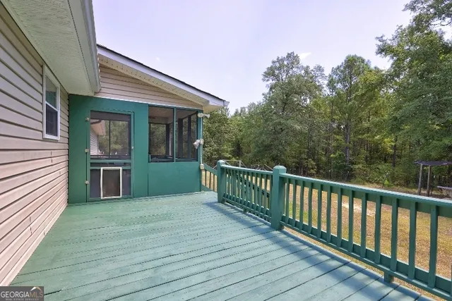 a view of a house with pool and wooden floor