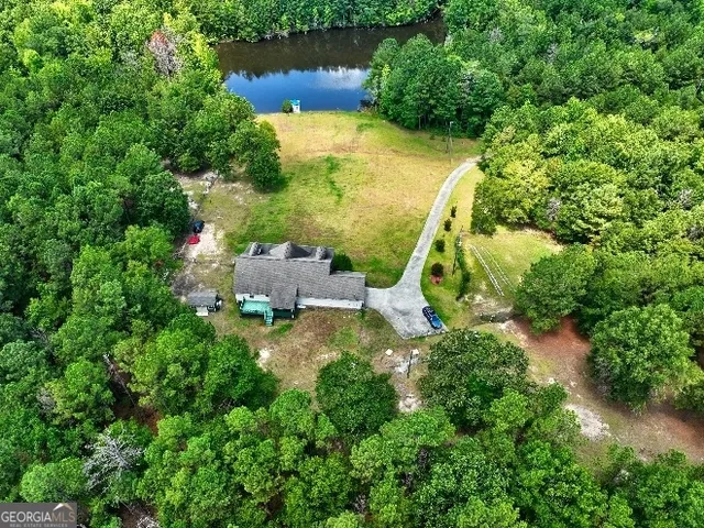an aerial view of a house with a yard