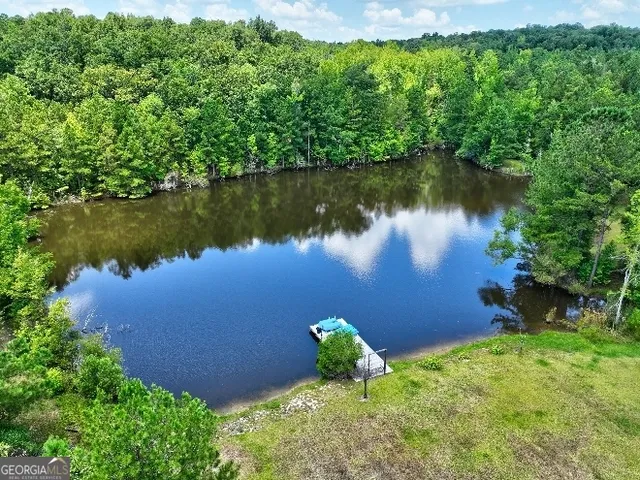 an aerial view of a house with a yard basket ball court and outdoor seating