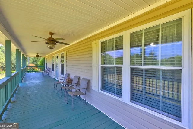 a view of a porch with wooden floor and a table