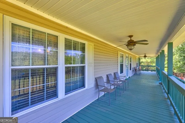 a view of a porch with wooden floor and iron stairs