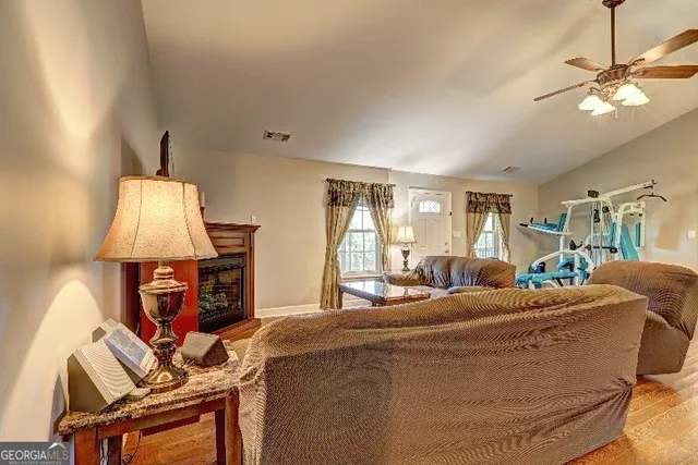 a living room with furniture a fireplace and a flat screen tv