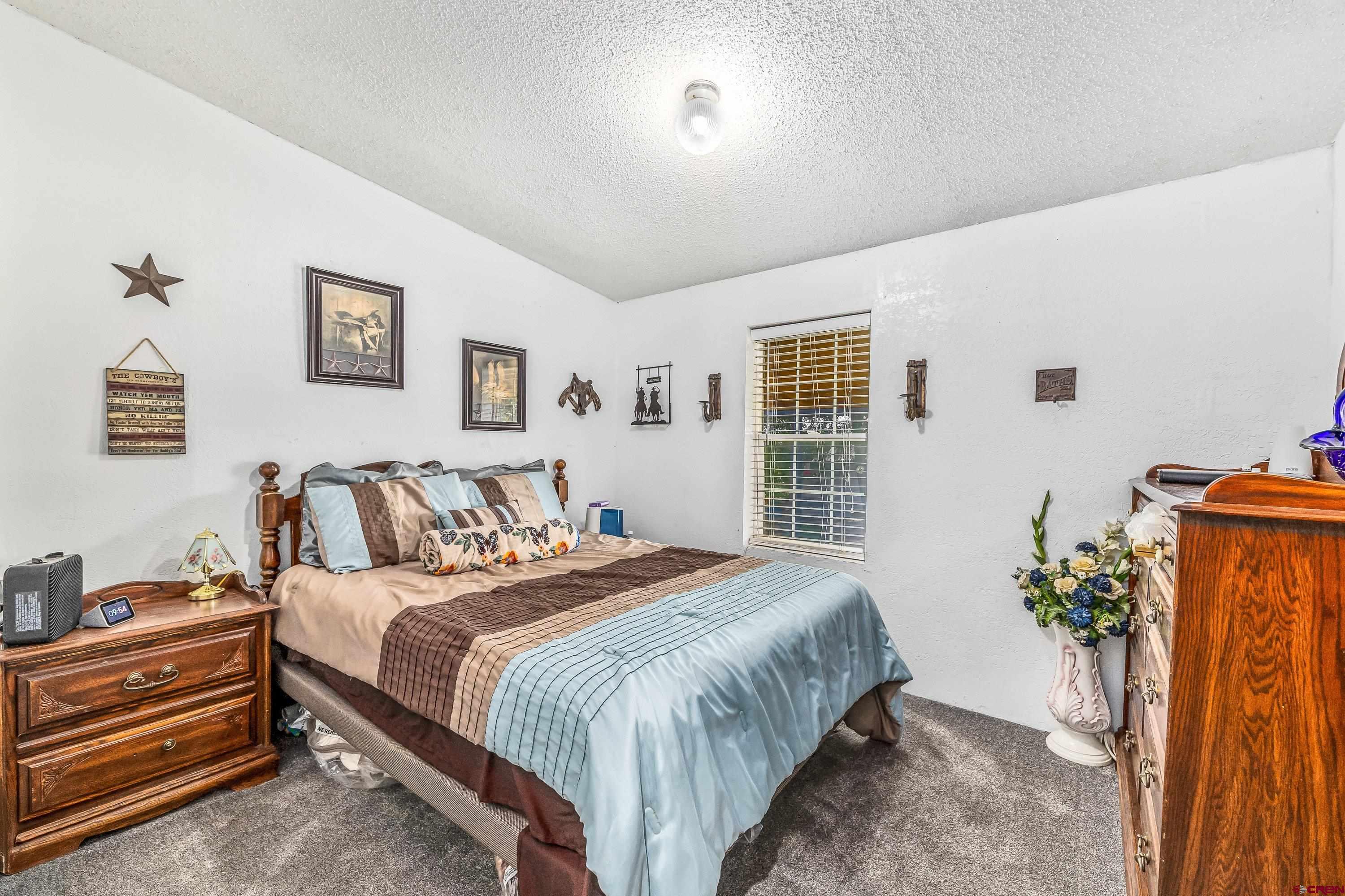 58703 Ida Road Olathe, CO 81425 - Photo 14 of 23 a bedroom with a bed and a window