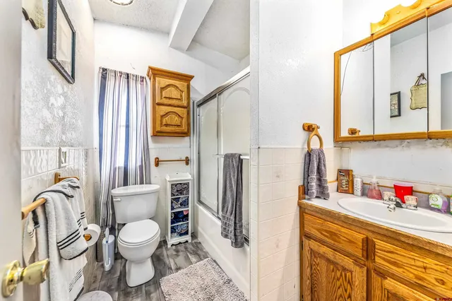 a bathroom with a sink a toilet and a shower curtain
