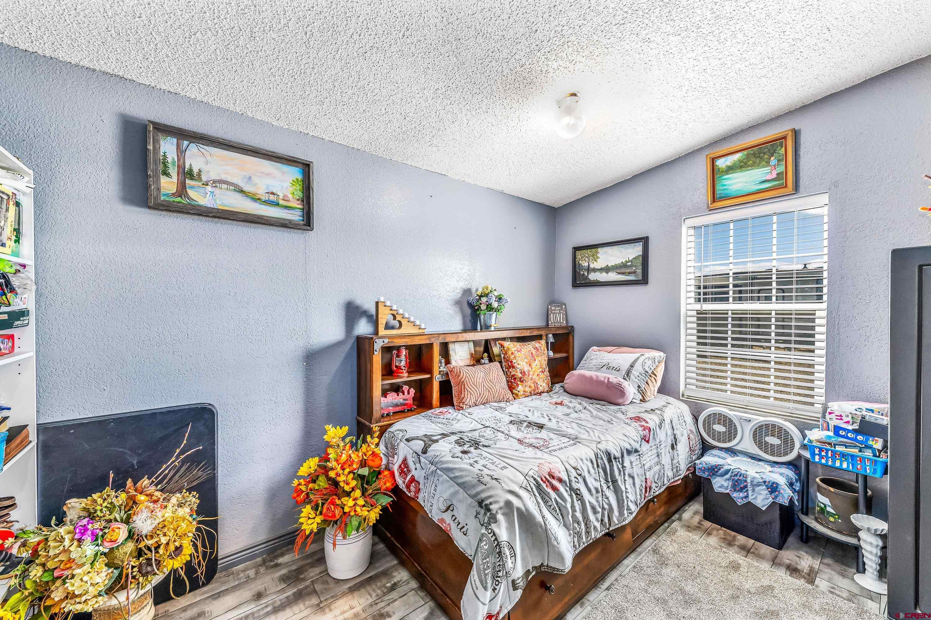 58703 Ida Road Olathe, CO 81425 - Photo 16 of 23 a bedroom with a bed and a window