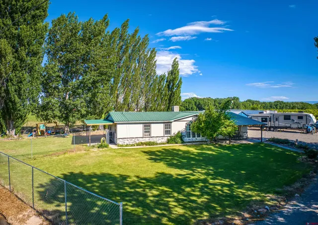 a view of a swimming pool with an outdoor seating and a yard