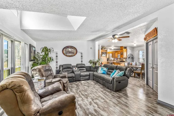 a living room with furniture a fireplace and a potted plant
