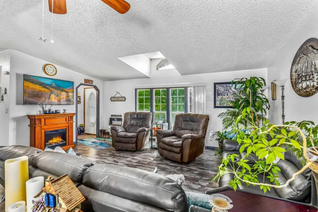 a living room with furniture a fireplace and a potted plant