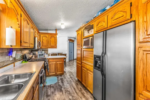 a kitchen with a refrigerator and a sink