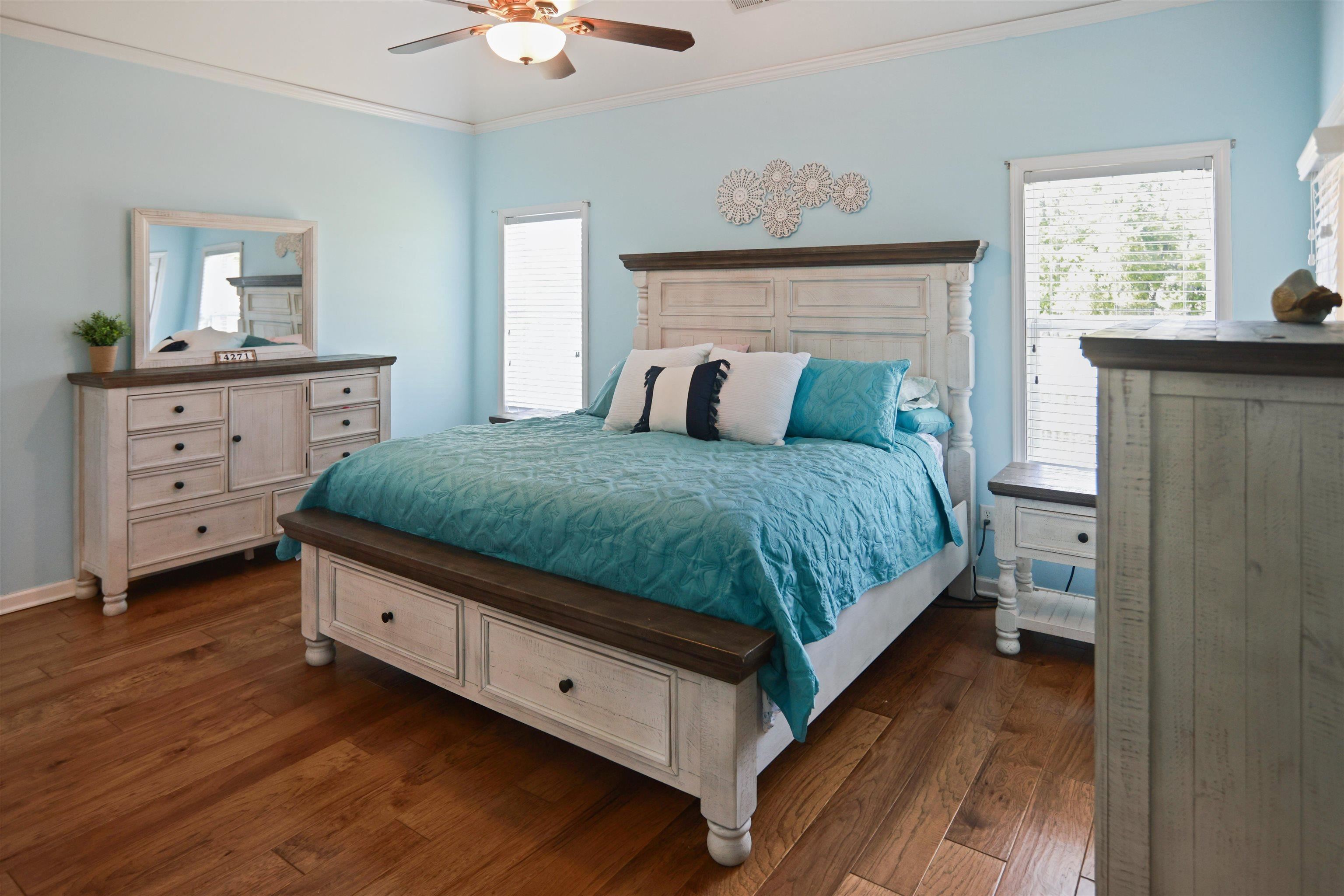 4271 Bay Bridge Road Lakeland, TN 38002 - Photo 13 of 37 Bedroom featuring dark wood-style floors, ornamental molding, multiple windows, and a ceiling fan