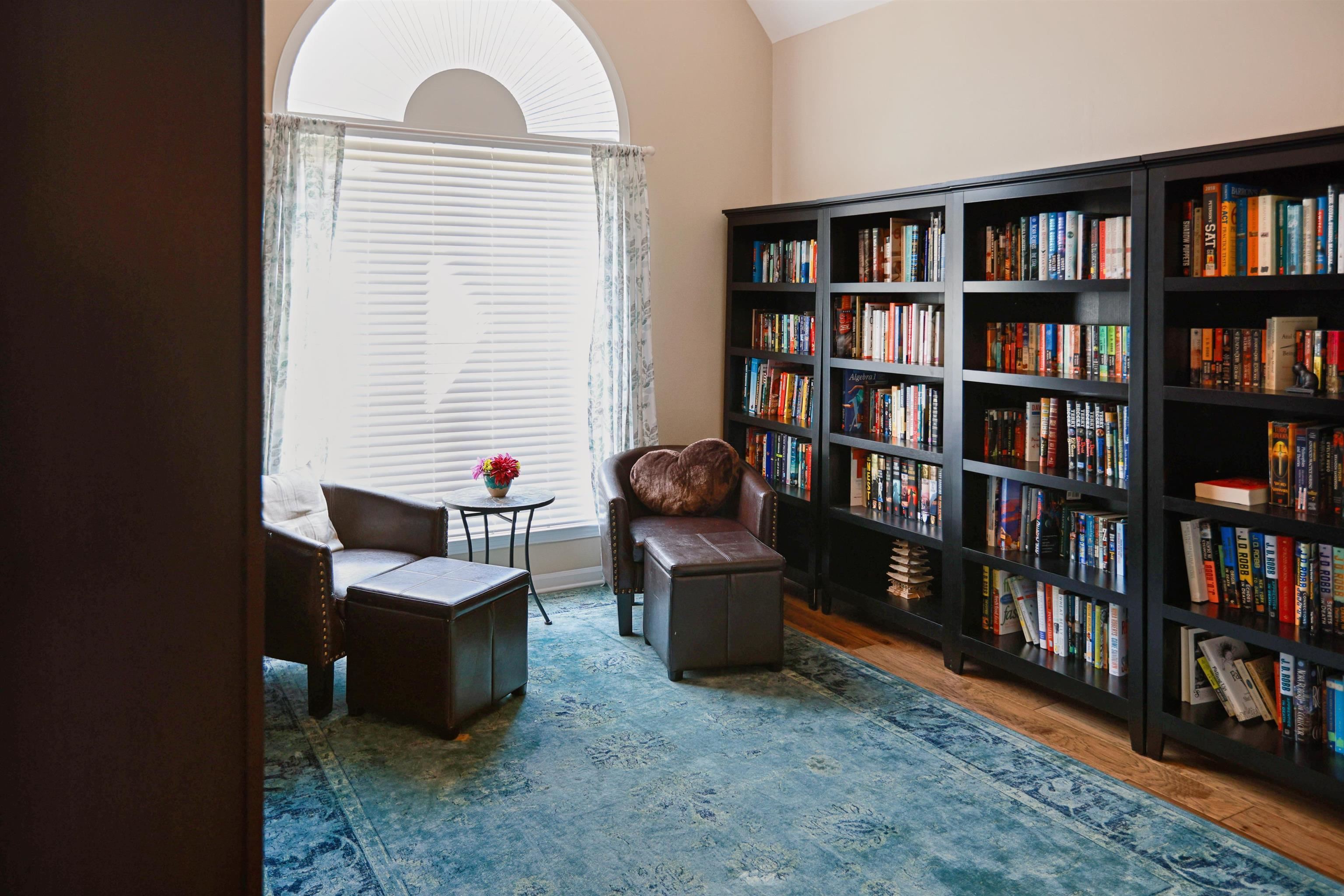 4271 Bay Bridge Road Lakeland, TN 38002 - Photo 18 of 37 Sitting room with wall of books, wood finished floors, and vaulted ceiling