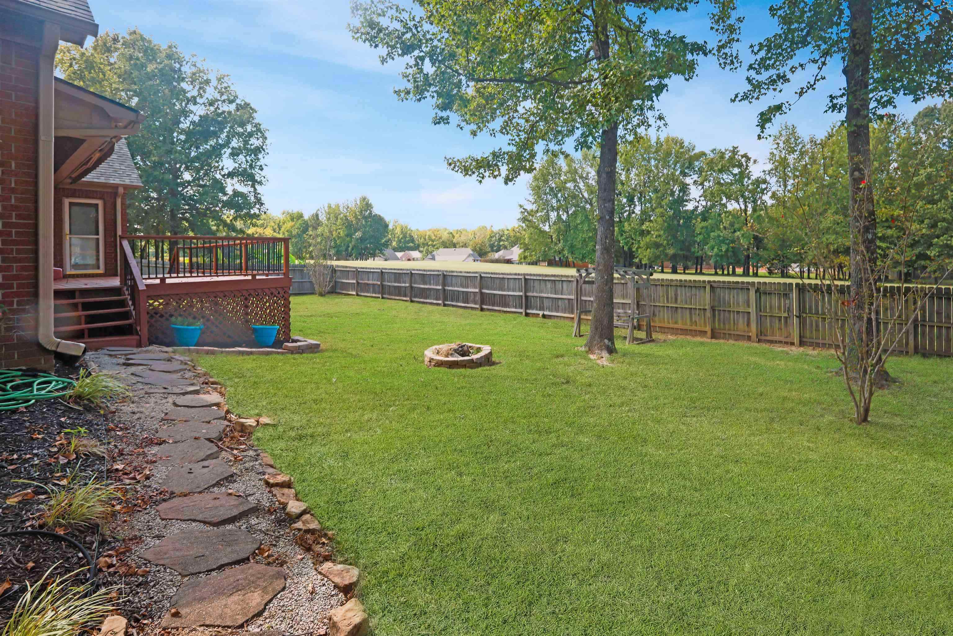 4271 Bay Bridge Road Lakeland, TN 38002 - Photo 29 of 37 Fenced backyard with a deck and a fire pit