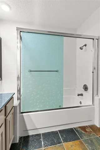 a bathroom with a bathtub and a shower