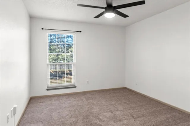 an empty room with a empty space and windows