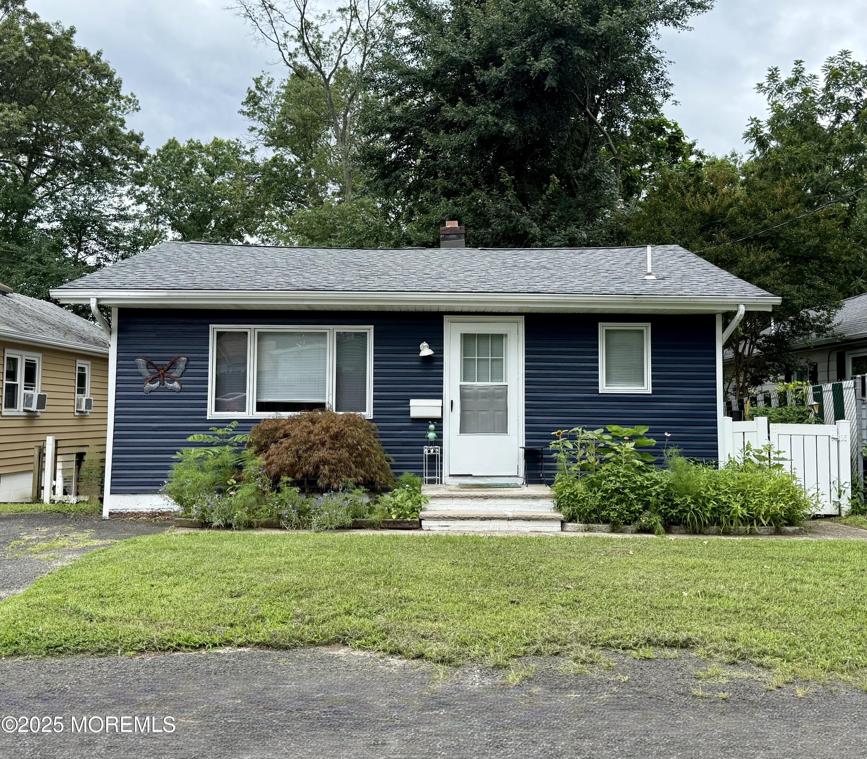13 Middlesex Avenue Keyport, NJ 07735 - Photo 12 of 12 a front view of a house with a garden