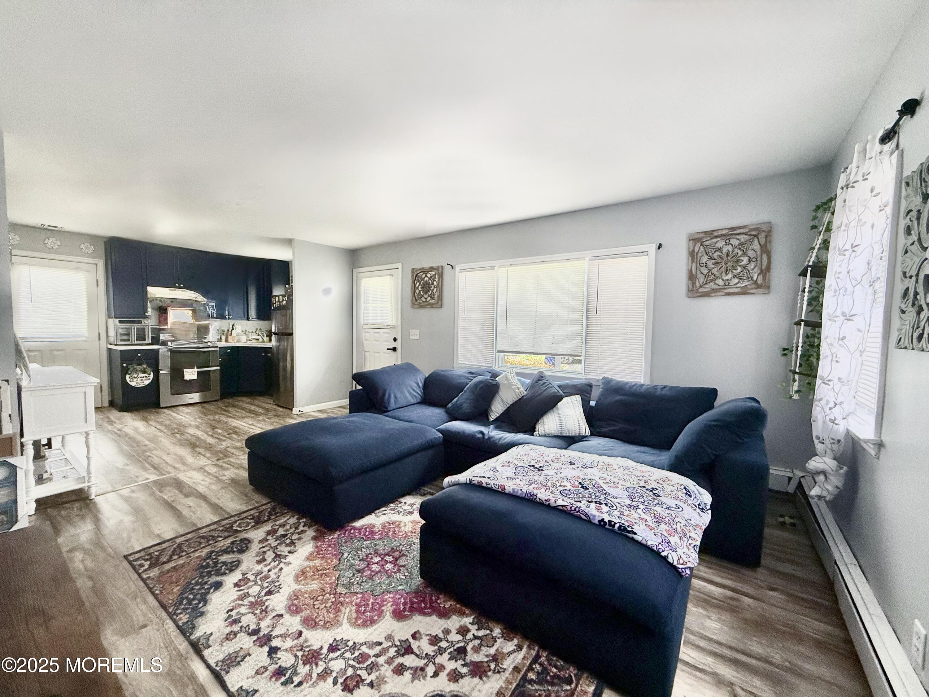 13 Middlesex Avenue Keyport, NJ 07735 - Photo 2 of 12 a living room with furniture and a wooden floor