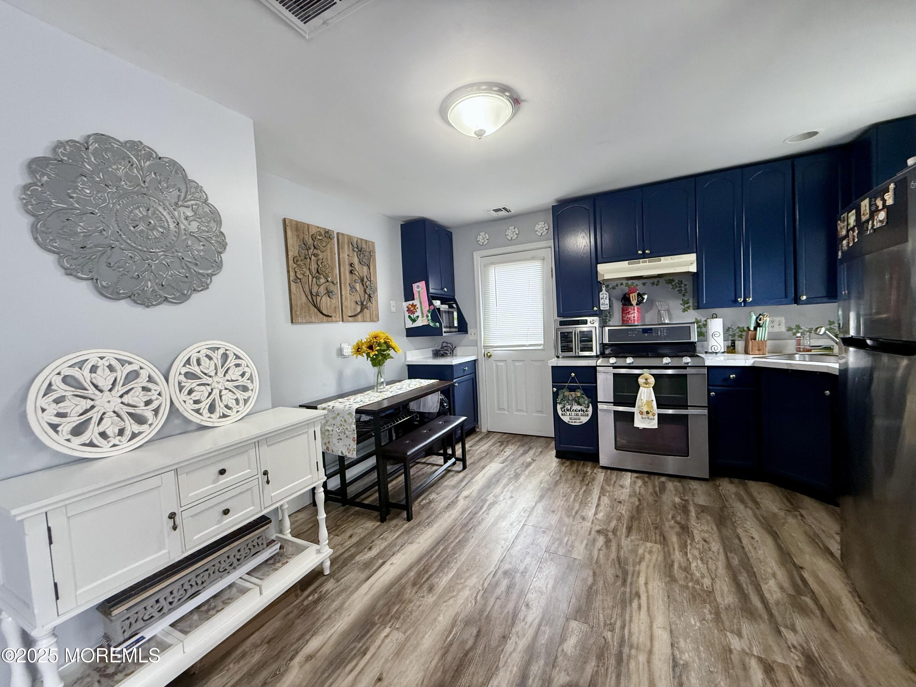 13 Middlesex Avenue Keyport, NJ 07735 - Photo 5 of 12 a kitchen with stainless steel appliances kitchen island granite countertop a refrigerator and a stove top oven