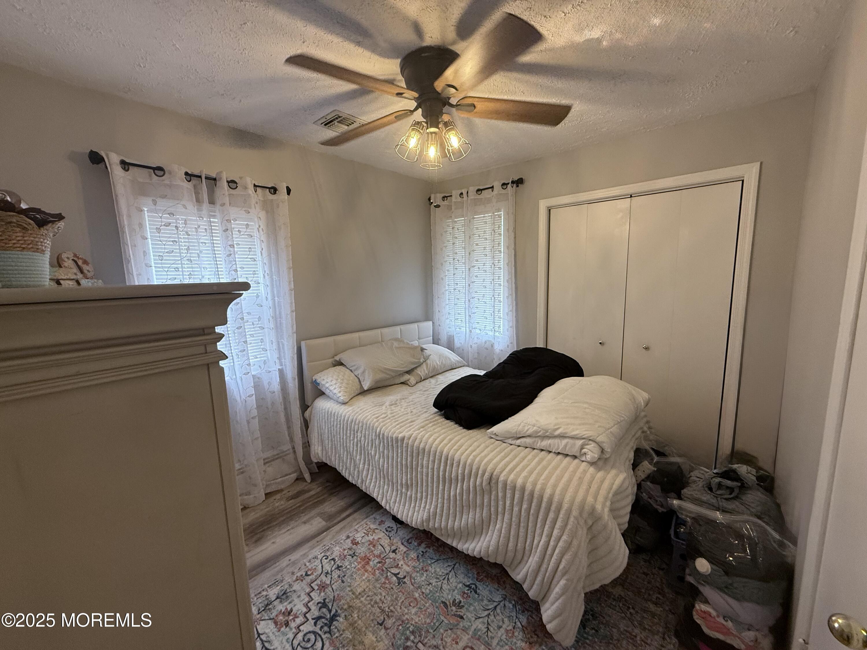 13 Middlesex Avenue Keyport, NJ 07735 - Photo 8 of 12 a bedroom with a bed and a chandelier