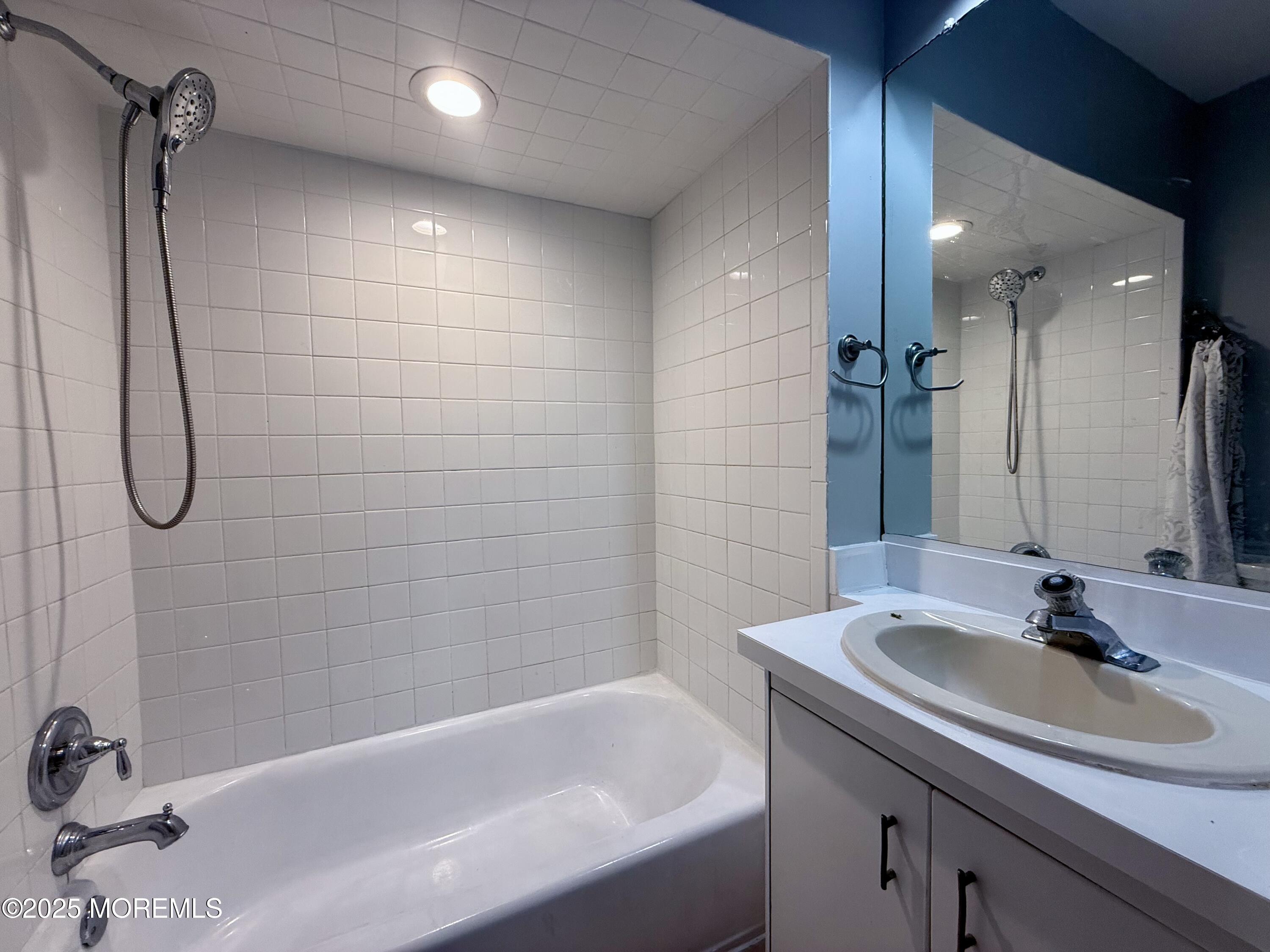 13 Middlesex Avenue Keyport, NJ 07735 - Photo 9 of 12 a bathroom with a tub sink shower and a mirror