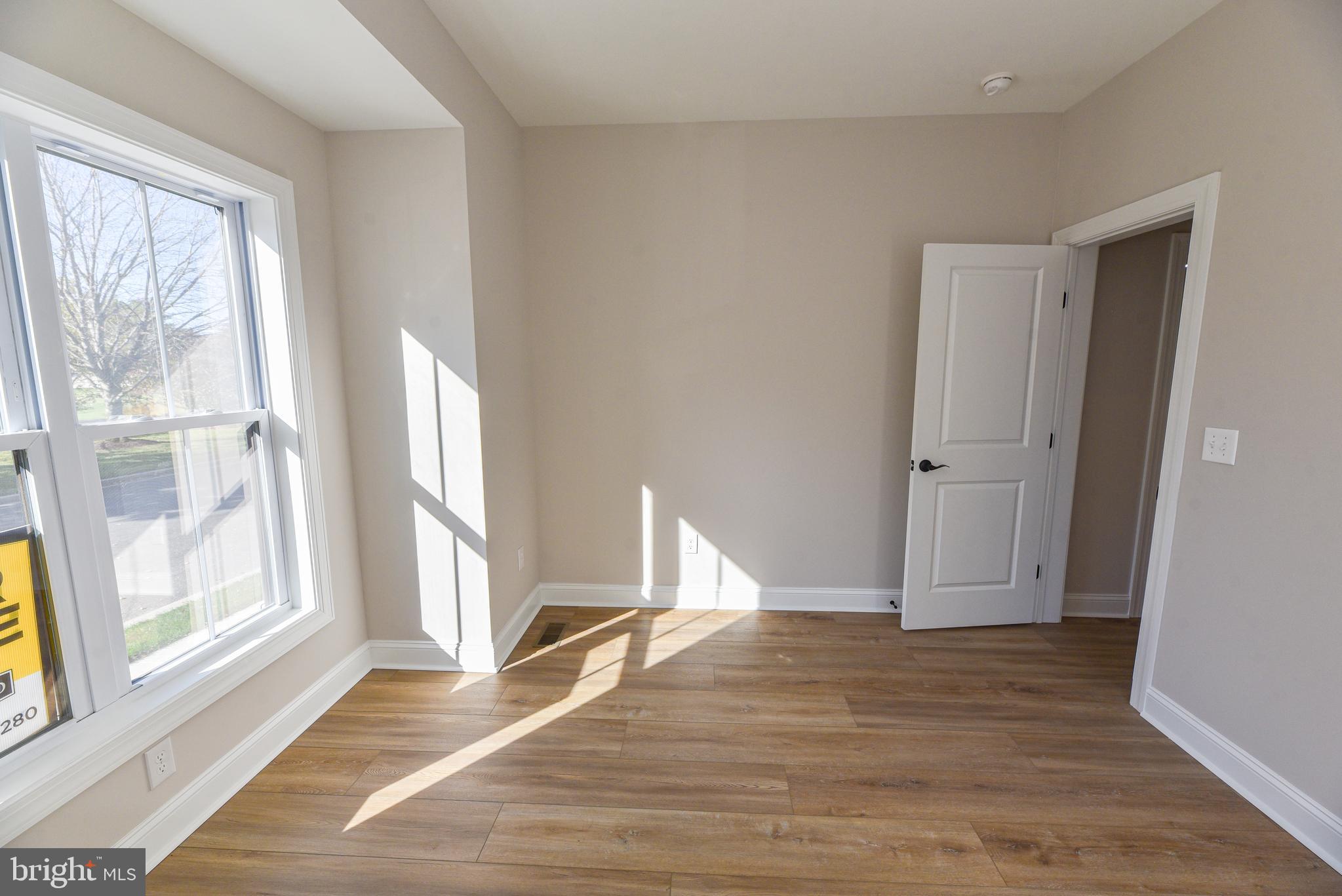 32667 Back Nine Way, Unit 3857 Long Neck, DE 19966 - Photo 11 of 74 a view of empty room with wooden floor and fan