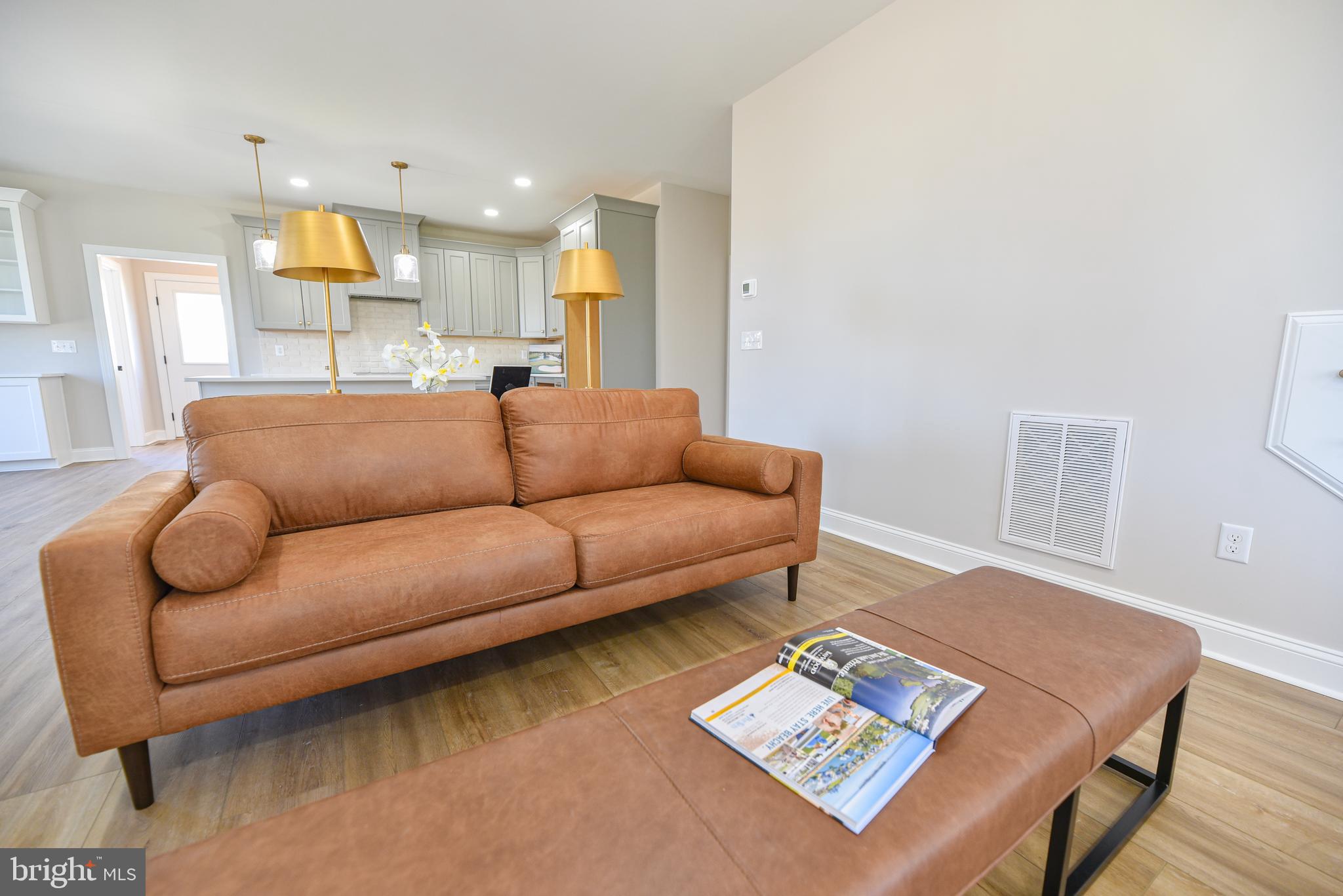 32667 Back Nine Way, Unit 3857 Long Neck, DE 19966 - Photo 15 of 74 a living room with furniture and a wooden floor