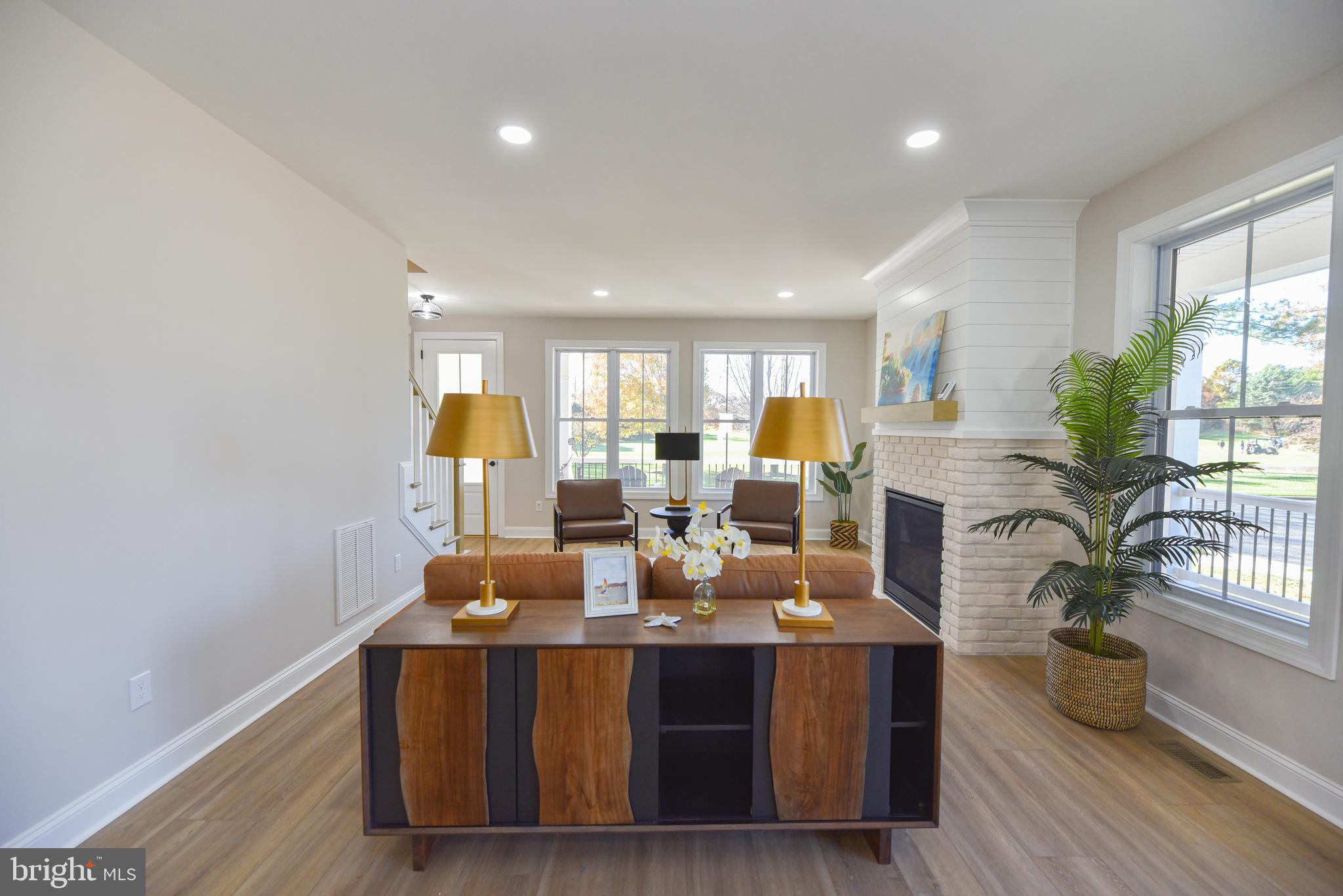 32667 Back Nine Way, Unit 3857 Long Neck, DE 19966 - Photo 19 of 74 a view of a dining room with furniture window and wooden floor
