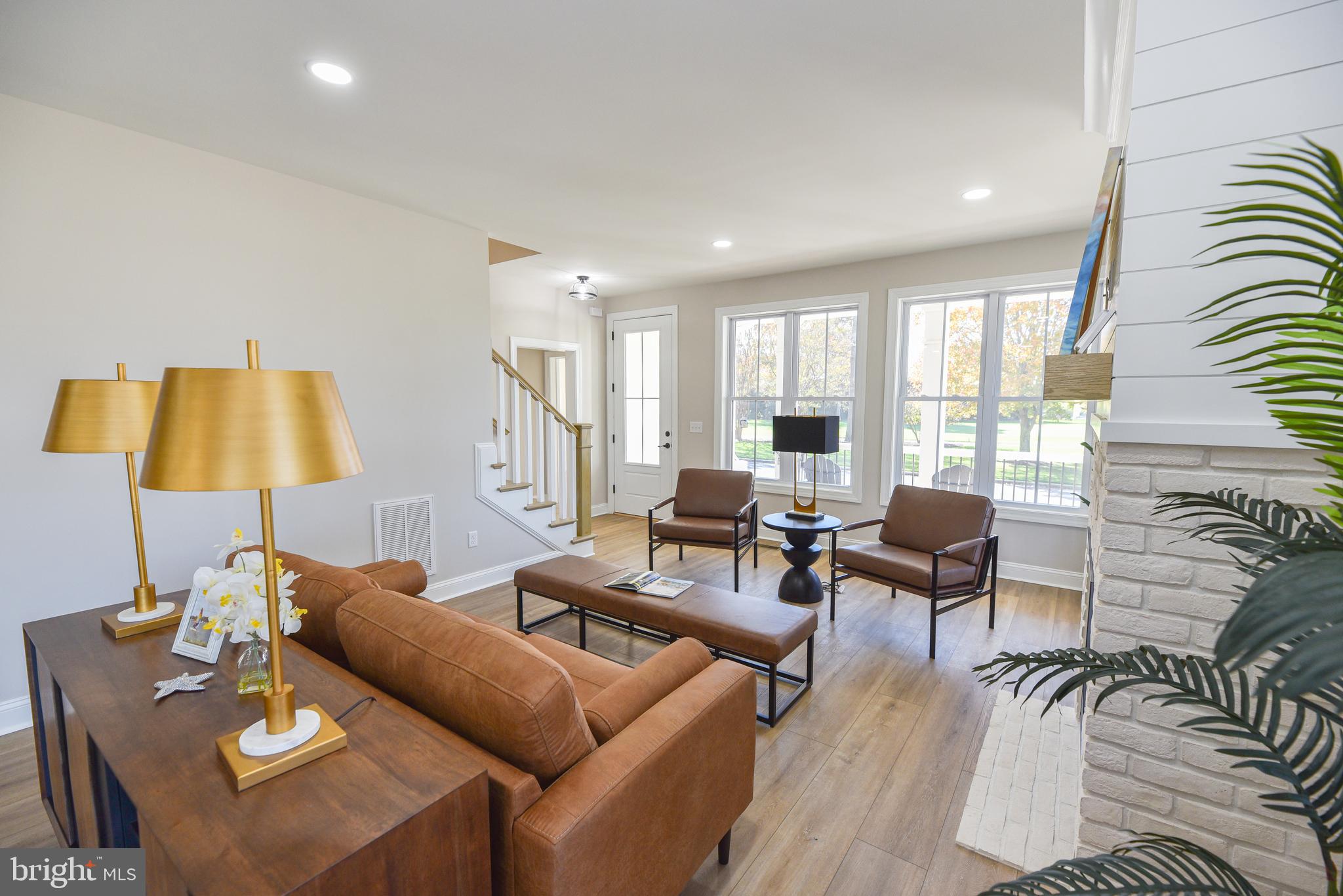 32667 Back Nine Way, Unit 3857 Long Neck, DE 19966 - Photo 20 of 74 a living room with furniture and a lamp