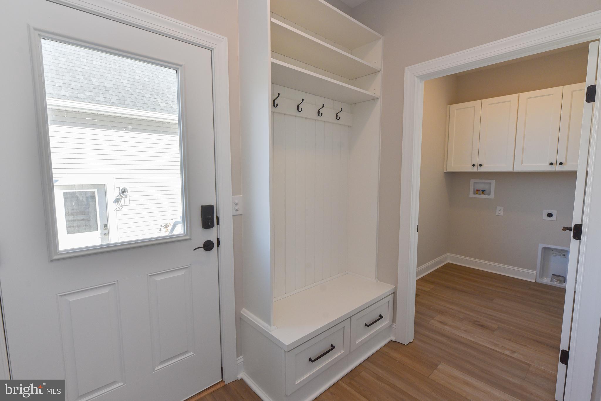 32667 Back Nine Way, Unit 3857 Long Neck, DE 19966 - Photo 33 of 74 a view of hallway with window and wooden floor