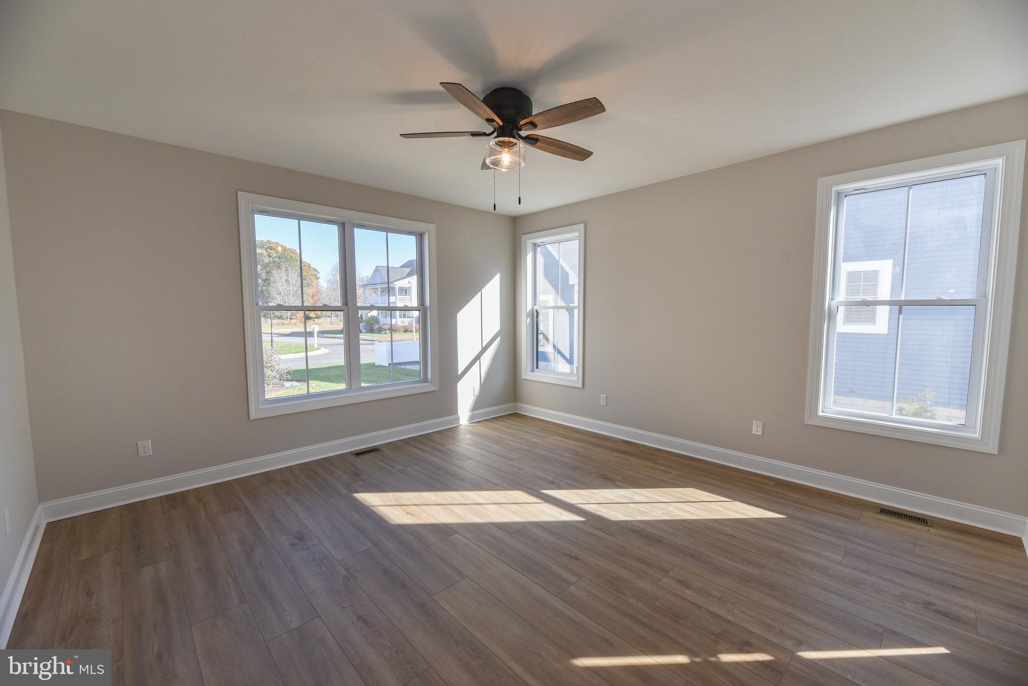 32667 Back Nine Way, Unit 3857 Long Neck, DE 19966 - Photo 39 of 74 a view of an empty room with wooden floor and a window