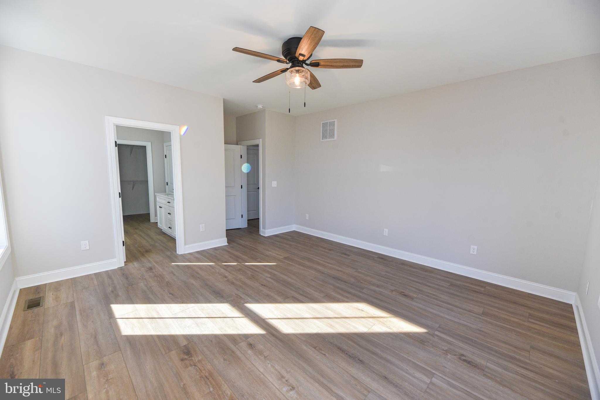 32667 Back Nine Way, Unit 3857 Long Neck, DE 19966 - Photo 40 of 74 wooden floor in an empty room with a window