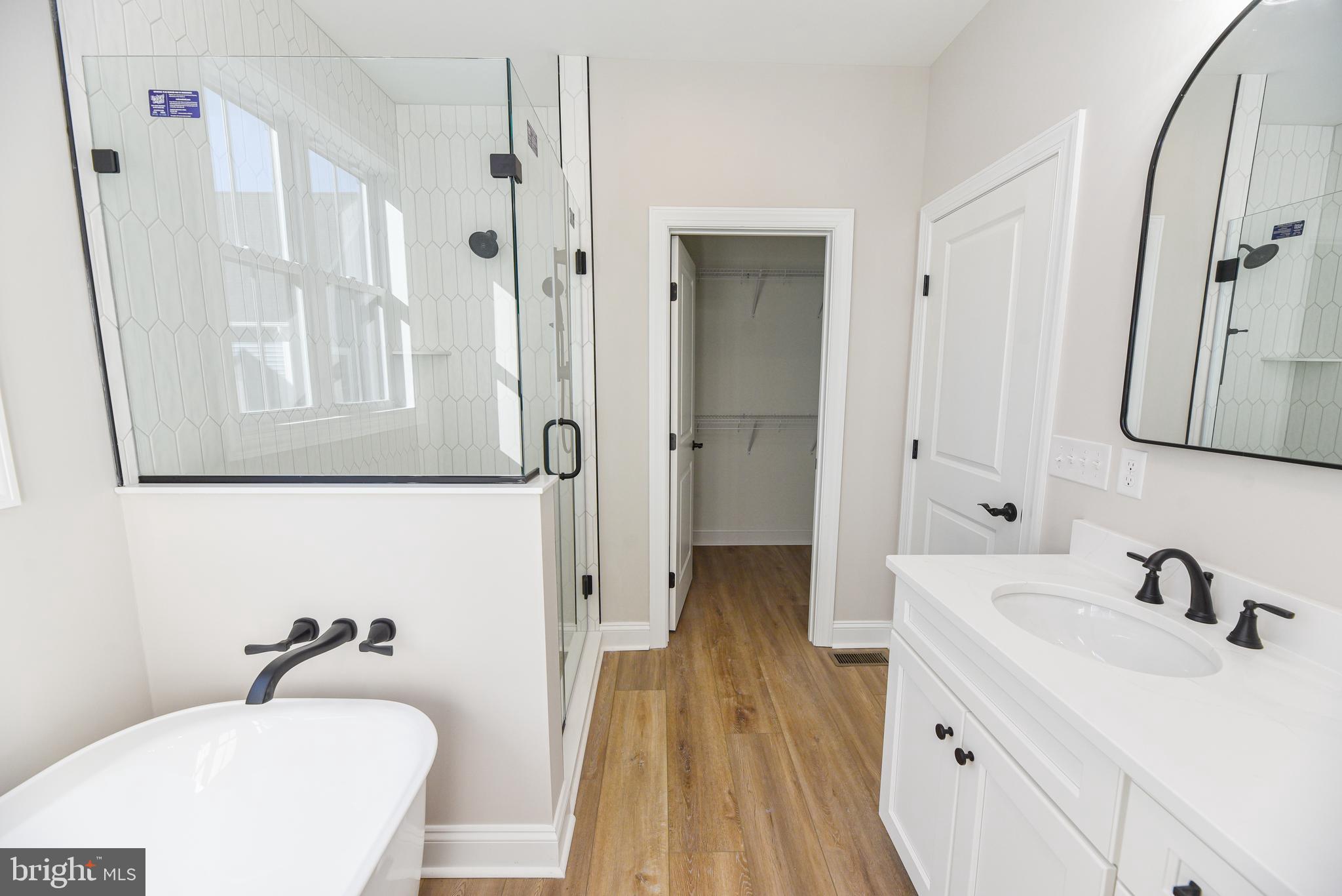 32667 Back Nine Way, Unit 3857 Long Neck, DE 19966 - Photo 41 of 74 a bathroom with a sink a toilet a tub and shower