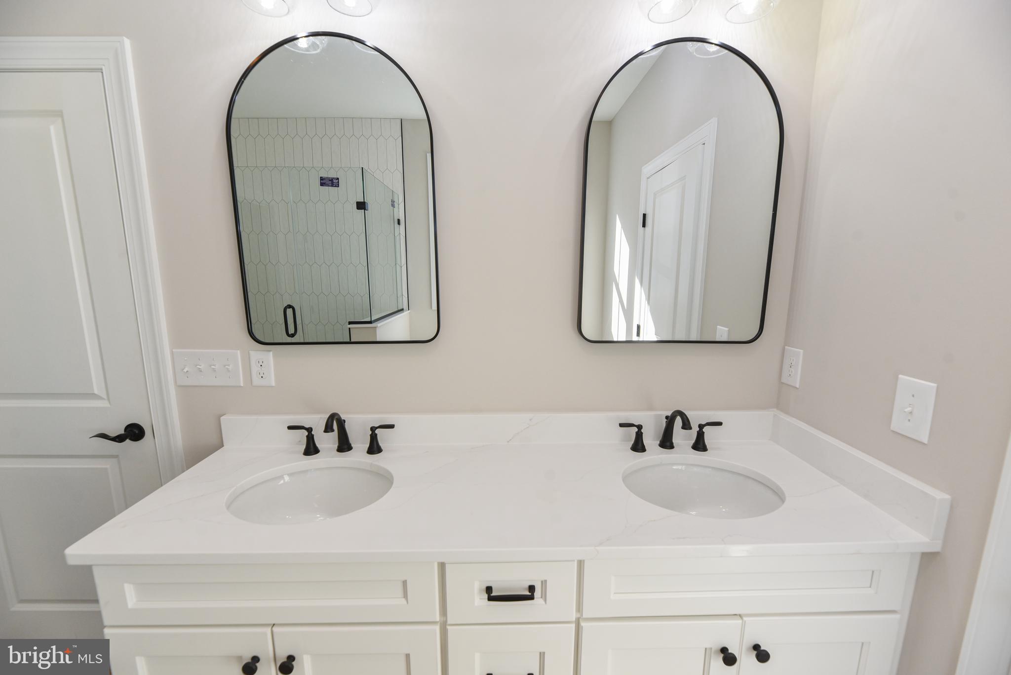 32667 Back Nine Way, Unit 3857 Long Neck, DE 19966 - Photo 44 of 74 a bathroom with double vanity sinks and a mirror