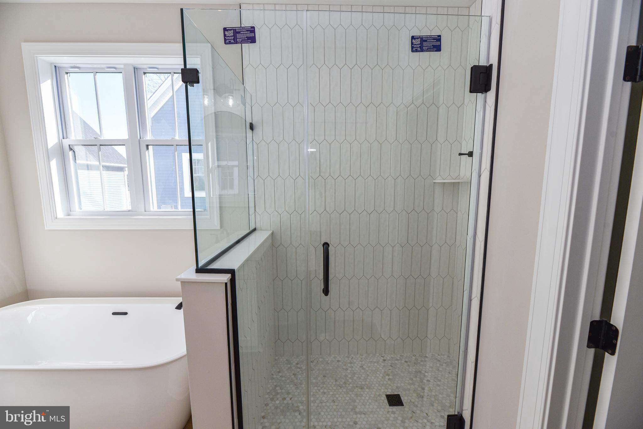 32667 Back Nine Way, Unit 3857 Long Neck, DE 19966 - Photo 46 of 74 a bathroom with a tub a sink and a window
