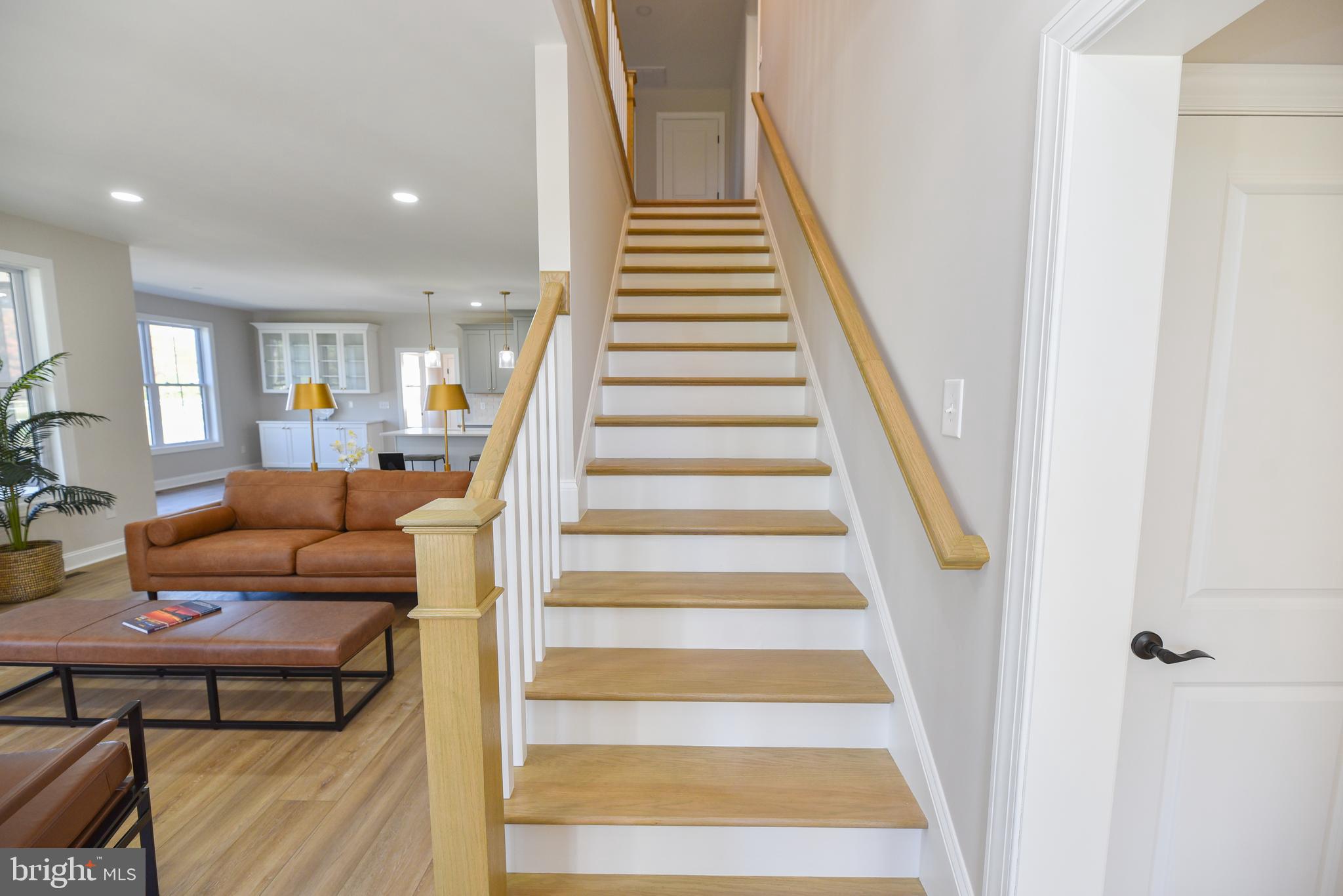 32667 Back Nine Way, Unit 3857 Long Neck, DE 19966 - Photo 5 of 74 a living room with furniture and a stair
