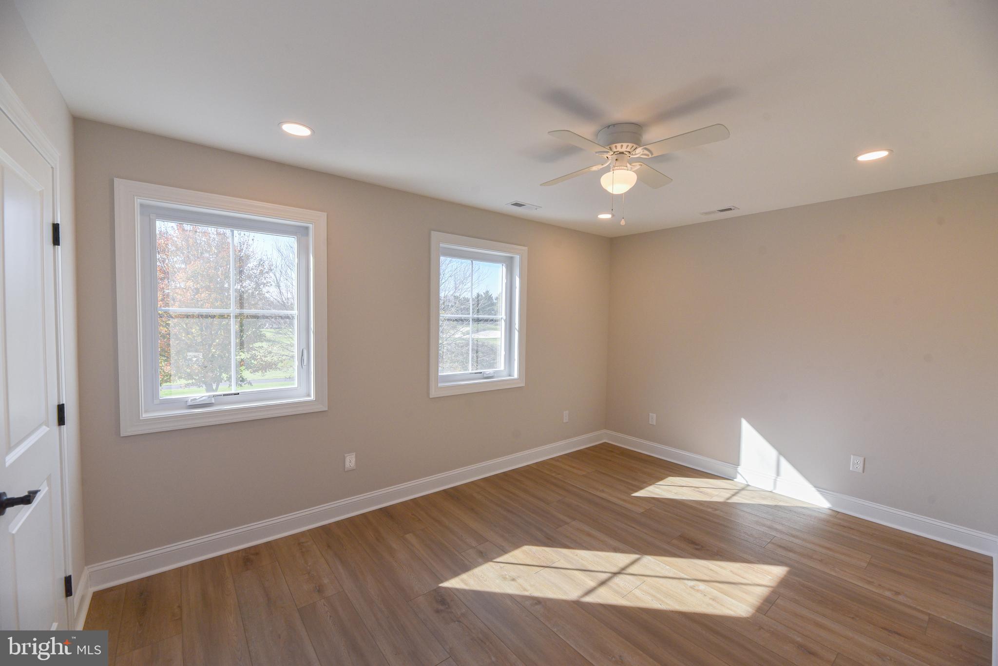 32667 Back Nine Way, Unit 3857 Long Neck, DE 19966 - Photo 52 of 74 a view of an empty room with wooden floor and a window