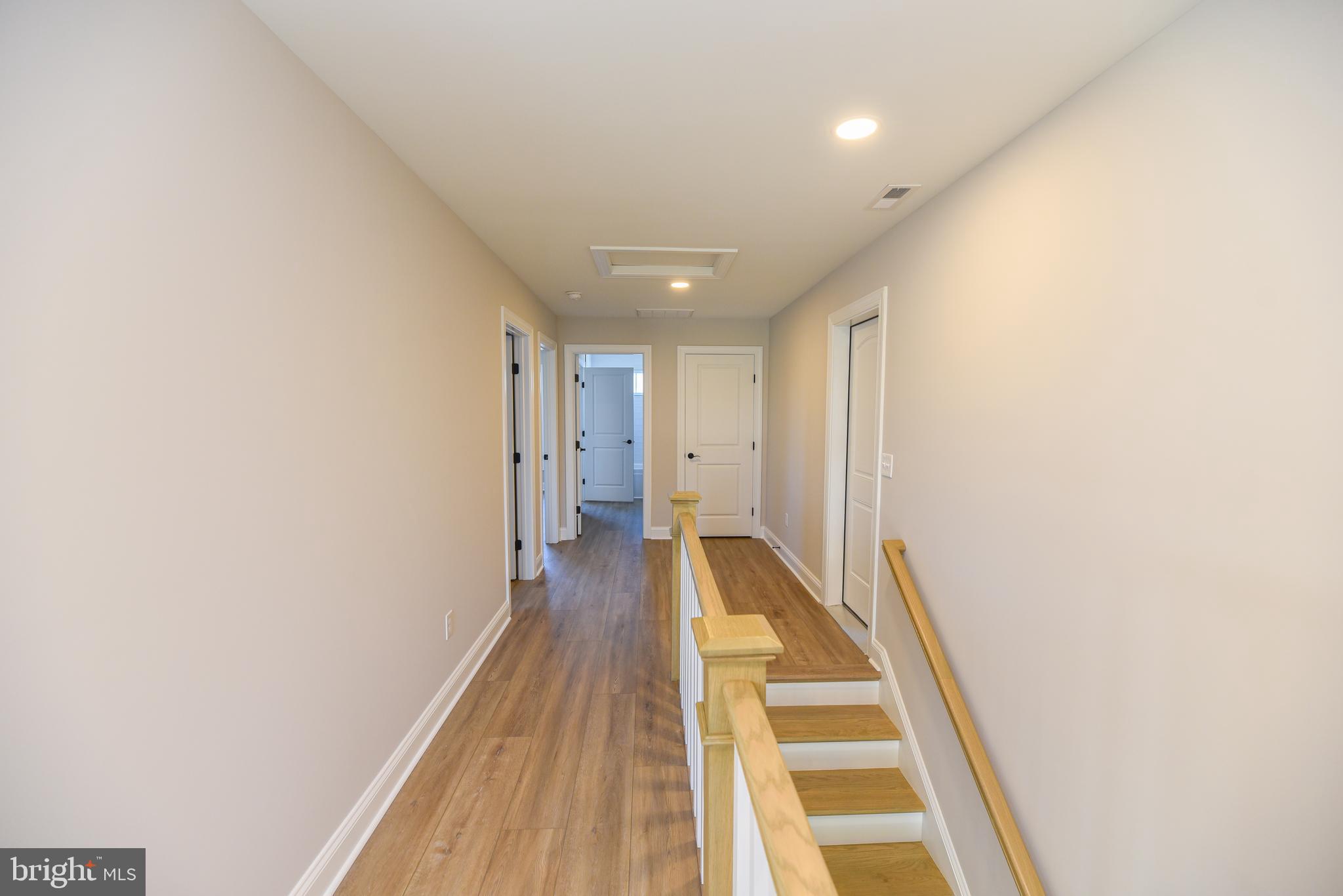 32667 Back Nine Way, Unit 3857 Long Neck, DE 19966 - Photo 54 of 74 a view of a hallway with wooden floor and a bathroom