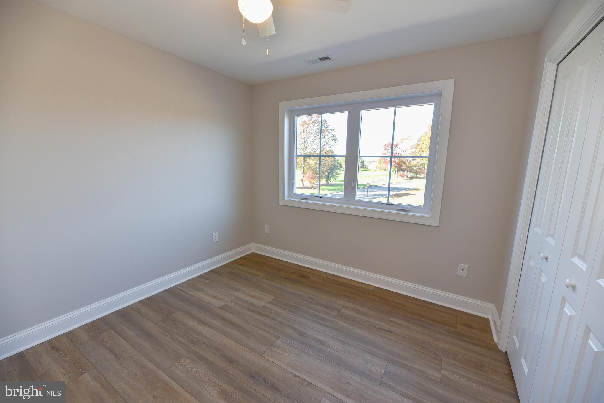 32667 Back Nine Way, Unit 3857 Long Neck, DE 19966 - Photo 55 of 74 a view of an empty room with wooden floor and a window