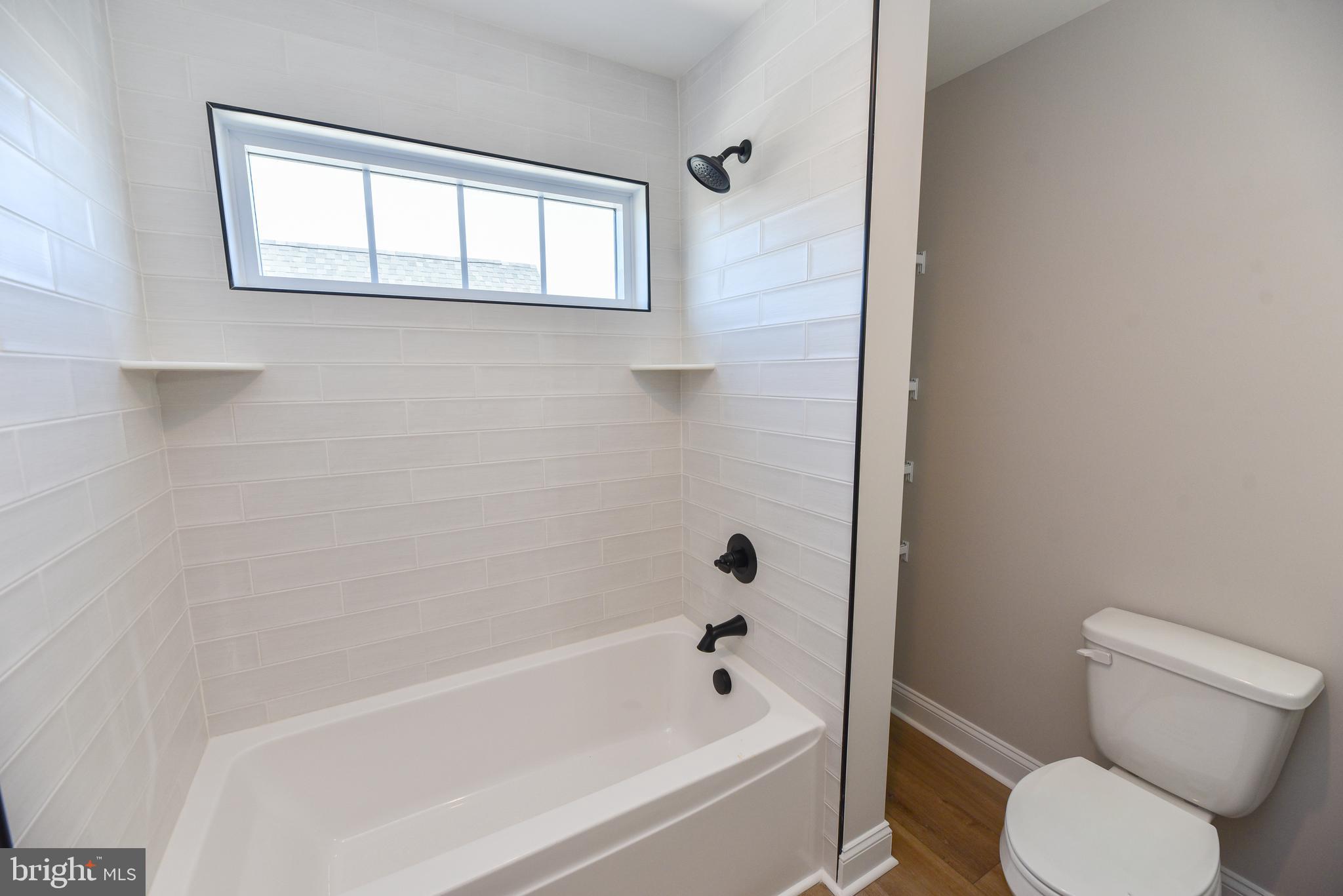 32667 Back Nine Way, Unit 3857 Long Neck, DE 19966 - Photo 59 of 74 a white bath tub sitting next to a toilet