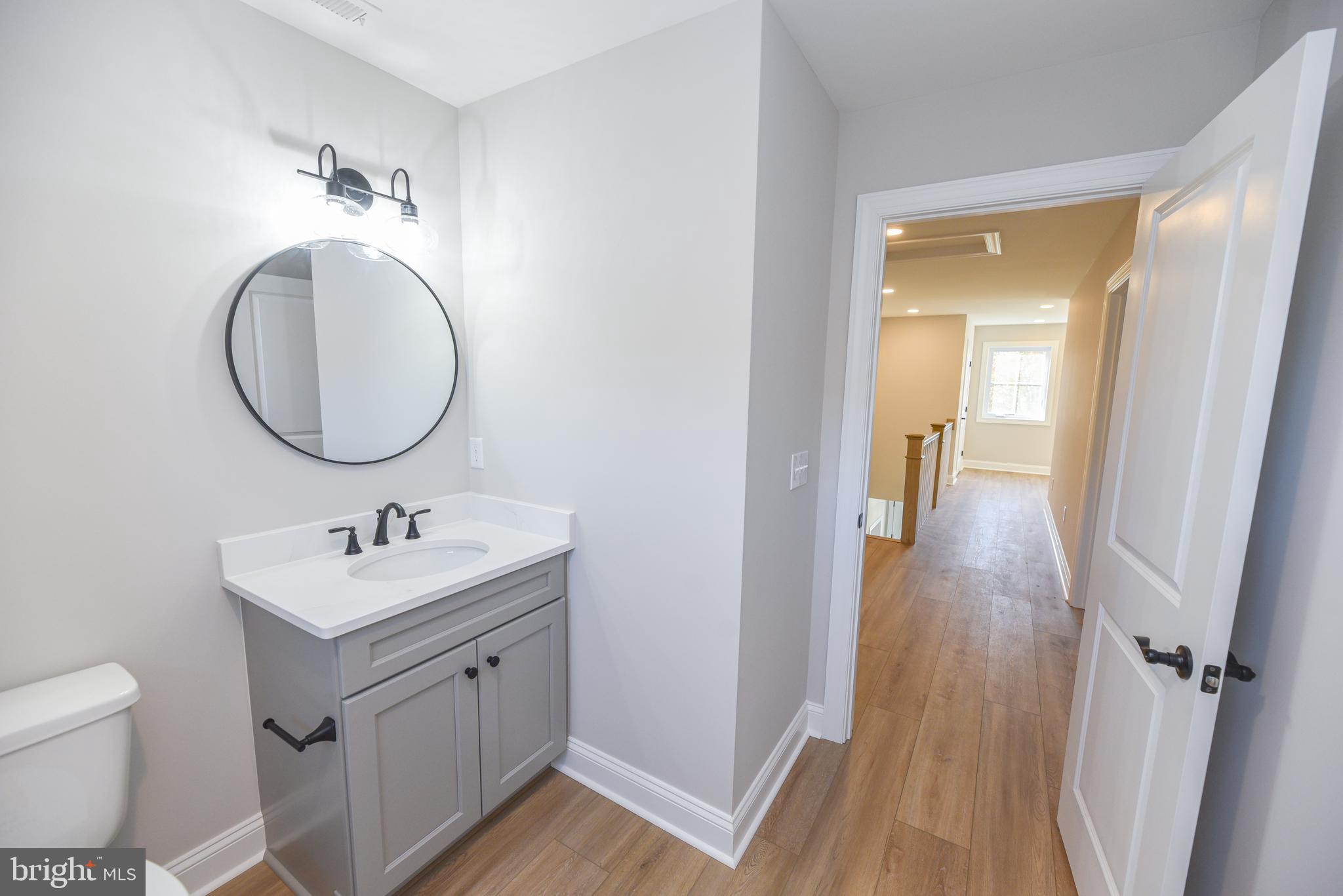 32667 Back Nine Way, Unit 3857 Long Neck, DE 19966 - Photo 60 of 74 a bathroom with a sink and a mirror