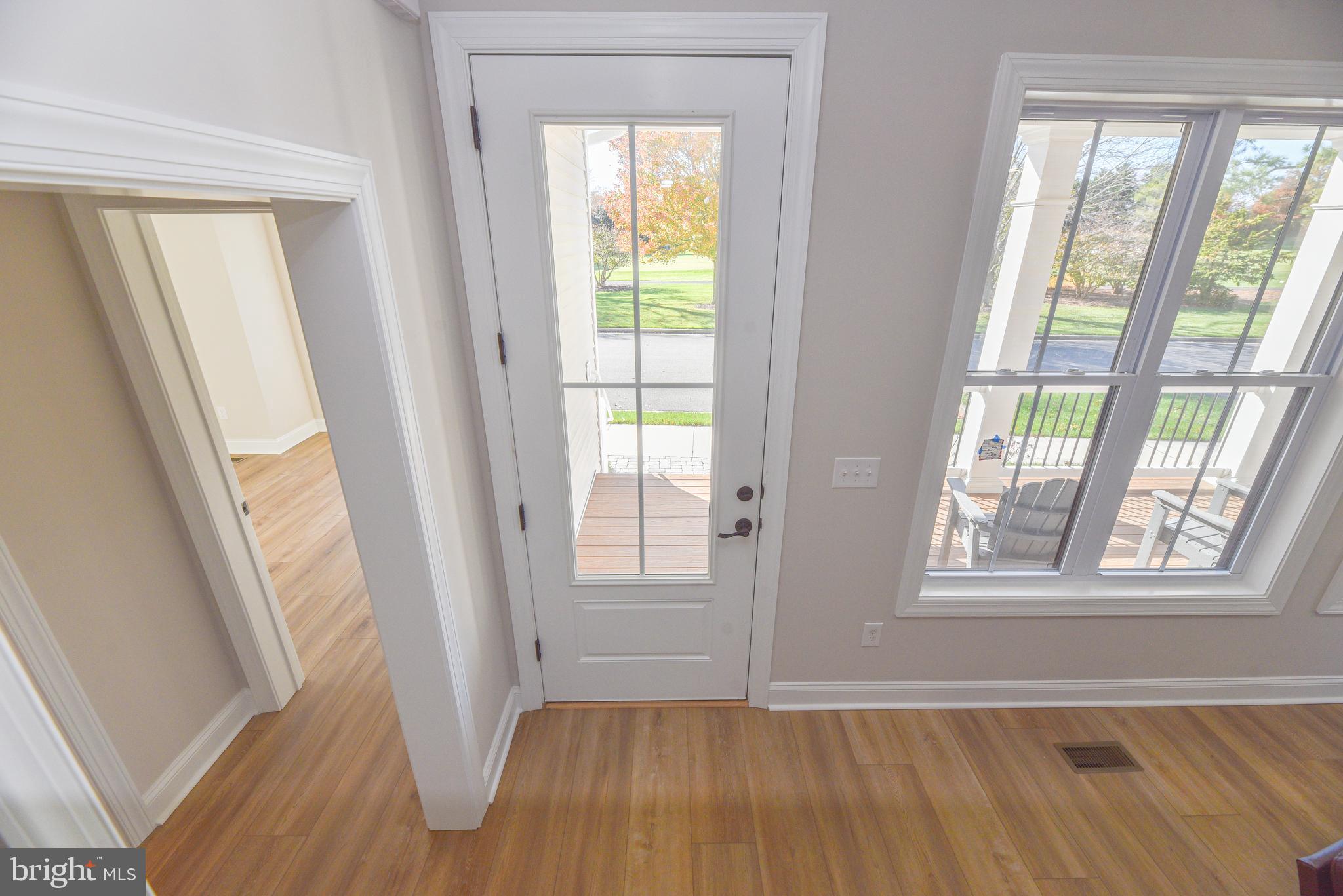 32667 Back Nine Way, Unit 3857 Long Neck, DE 19966 - Photo 65 of 74 a view of an empty room with wooden floor and a window