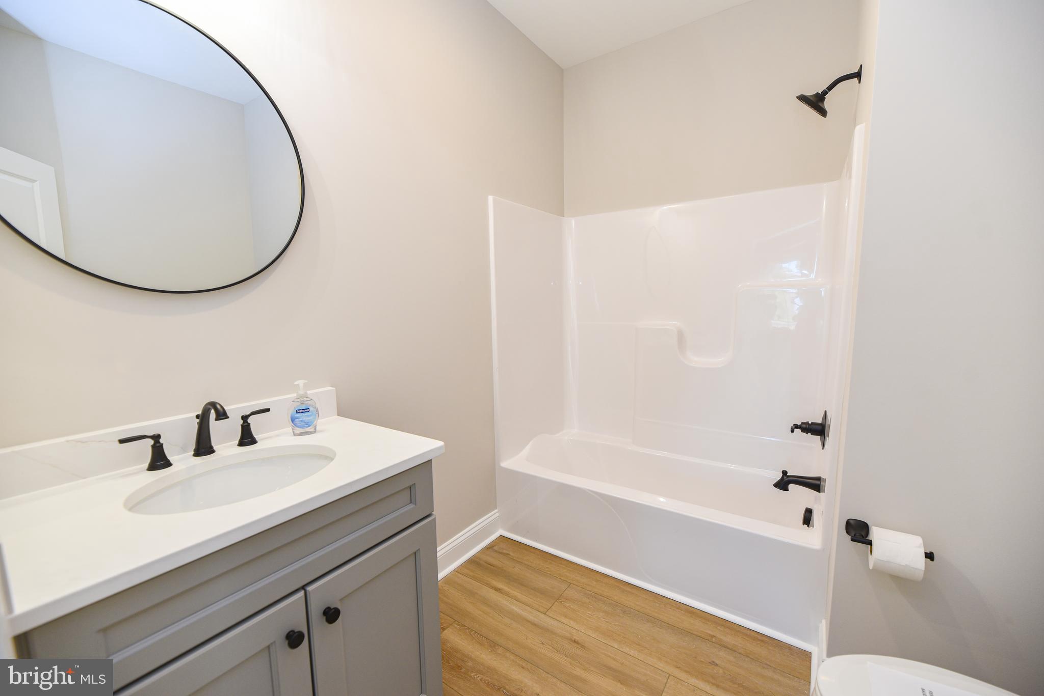 32667 Back Nine Way, Unit 3857 Long Neck, DE 19966 - Photo 7 of 74 a bathroom with a sink and a mirror