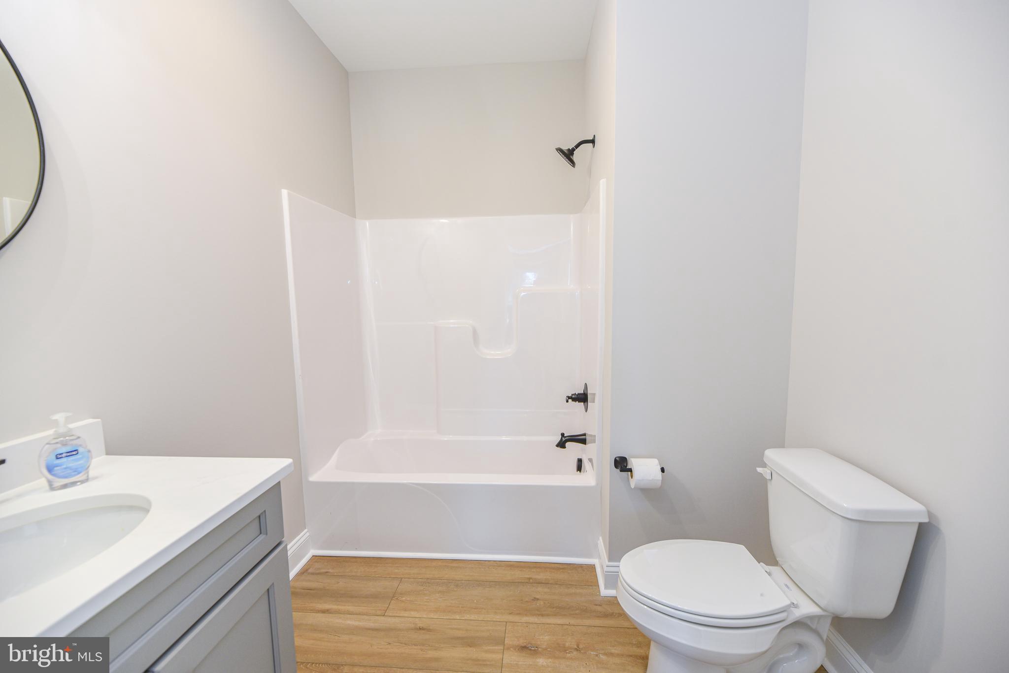 32667 Back Nine Way, Unit 3857 Long Neck, DE 19966 - Photo 8 of 74 a bathroom with a sink and a mirror