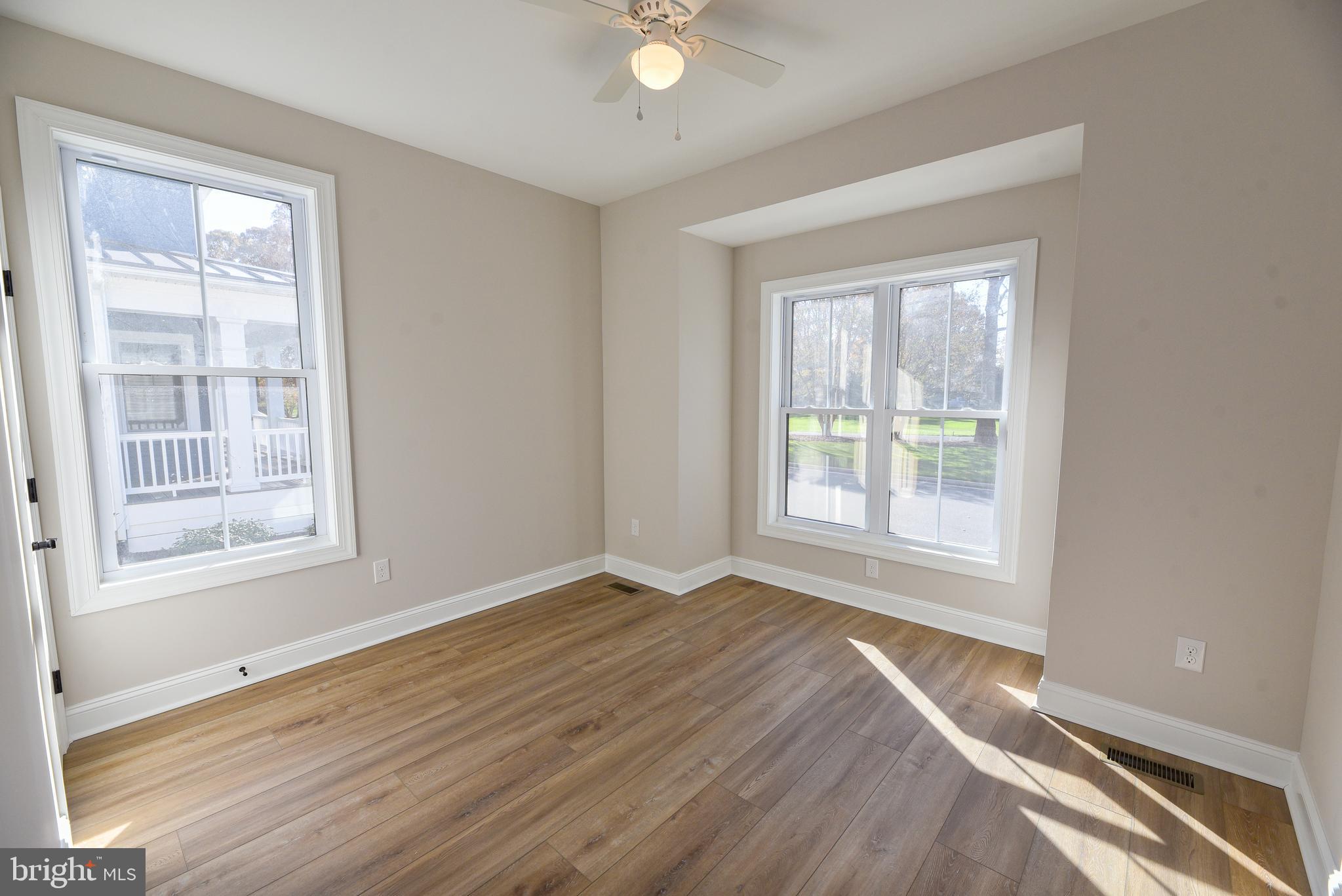 32667 Back Nine Way, Unit 3857 Long Neck, DE 19966 - Photo 9 of 74 an empty room with wooden floor and windows