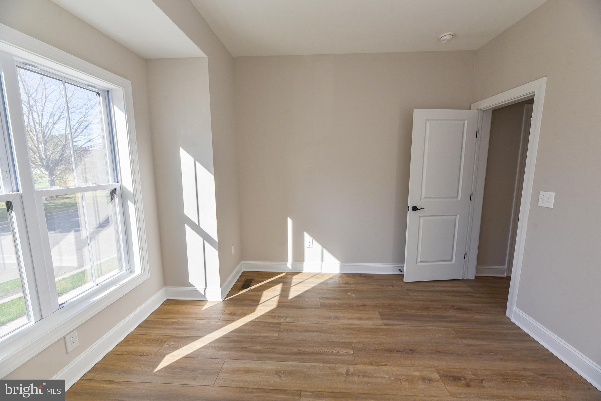 32667 Back Nine Way, Unit 3857 Long Neck, DE 19966 - Photo 10 of 74 a view of empty room with wooden floor and fan