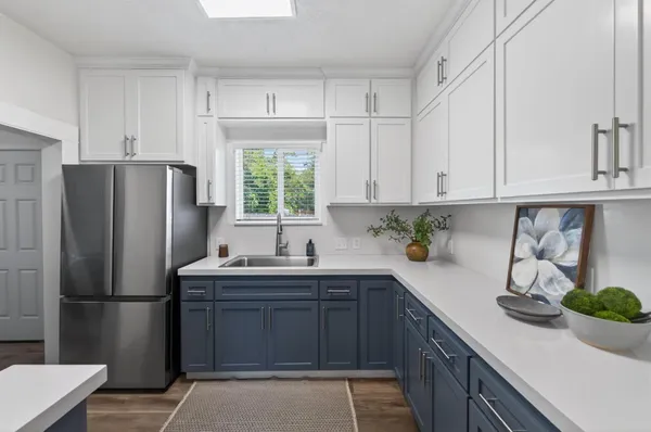 a kitchen with stainless steel appliances a refrigerator sink and cabinets